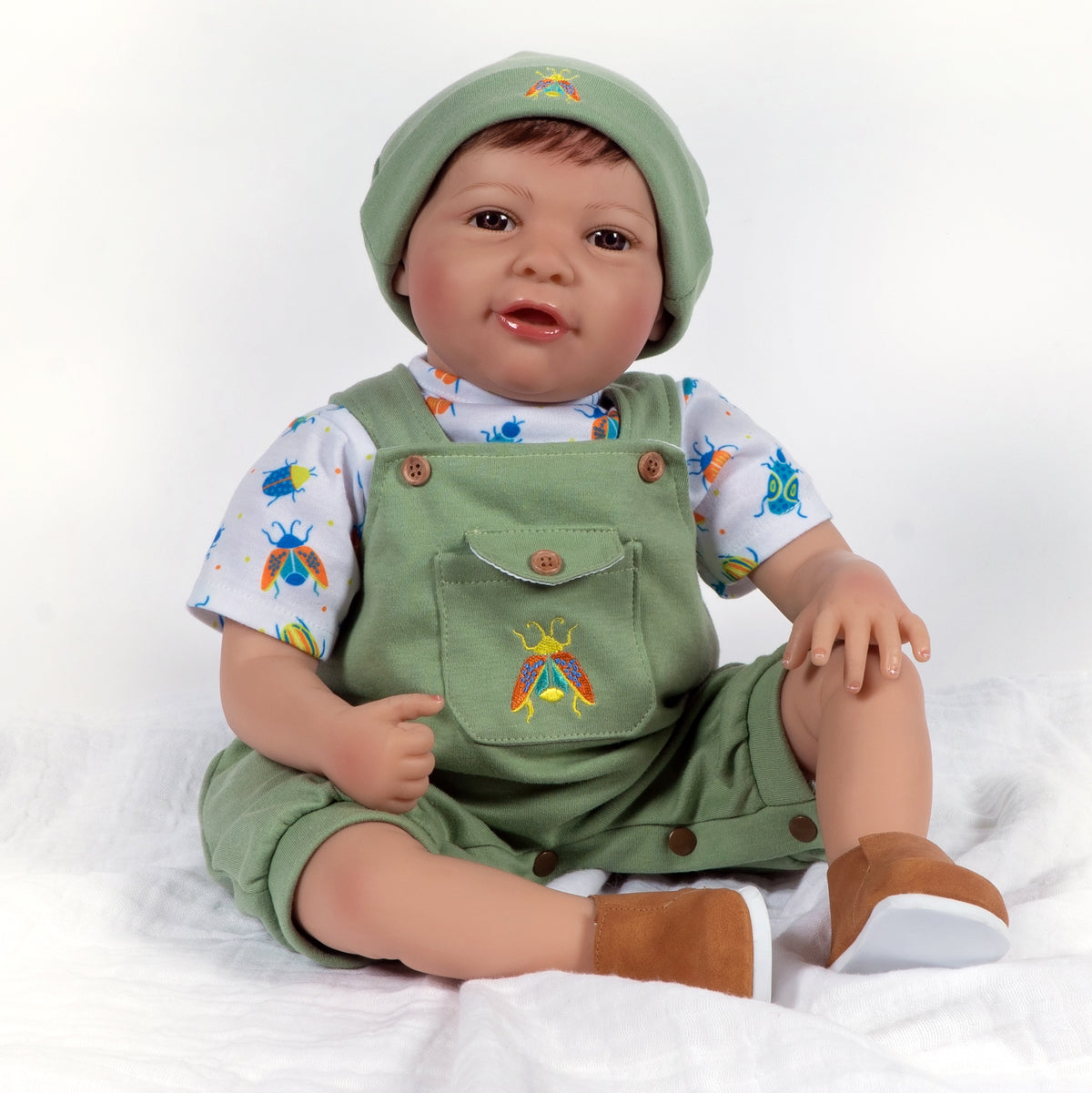 21 inch realistic toddler boy doll sculpted by doll artist Jannie de Lange. Crafted from our GentleTouch™ vinyl that gives that decadently soft and luxurious feel of real, baby-smooth skin, and comes with a weighted cloth body that features a more tapered realistic look and weighted bean bag bottom.