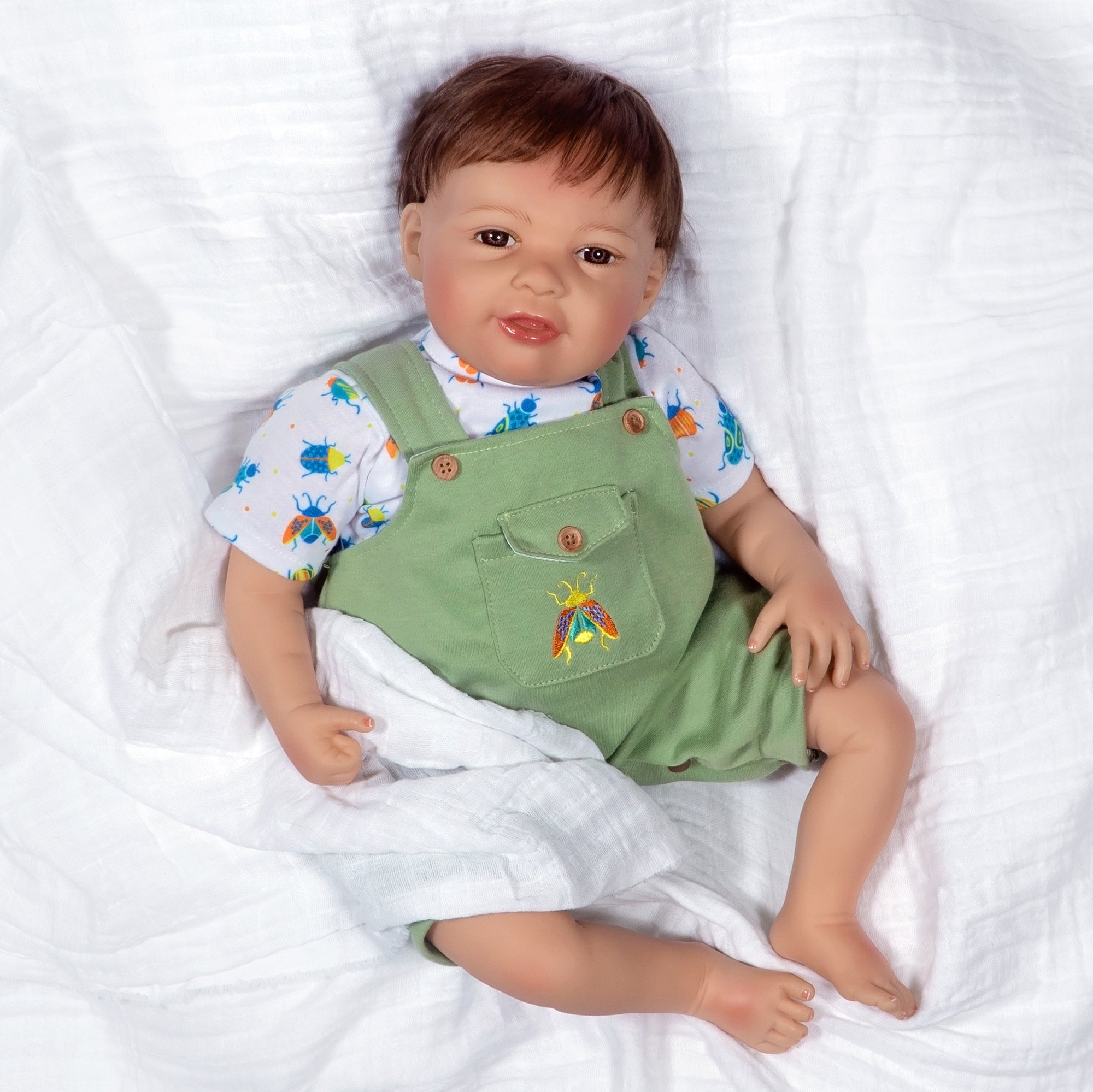 21 inch realistic toddler boy doll sculpted by doll artist Jannie de Lange. Crafted from our GentleTouch™ vinyl that gives that decadently soft and luxurious feel of real, baby-smooth skin, and comes with a weighted cloth body that features a more tapered realistic look and weighted bean bag bottom.