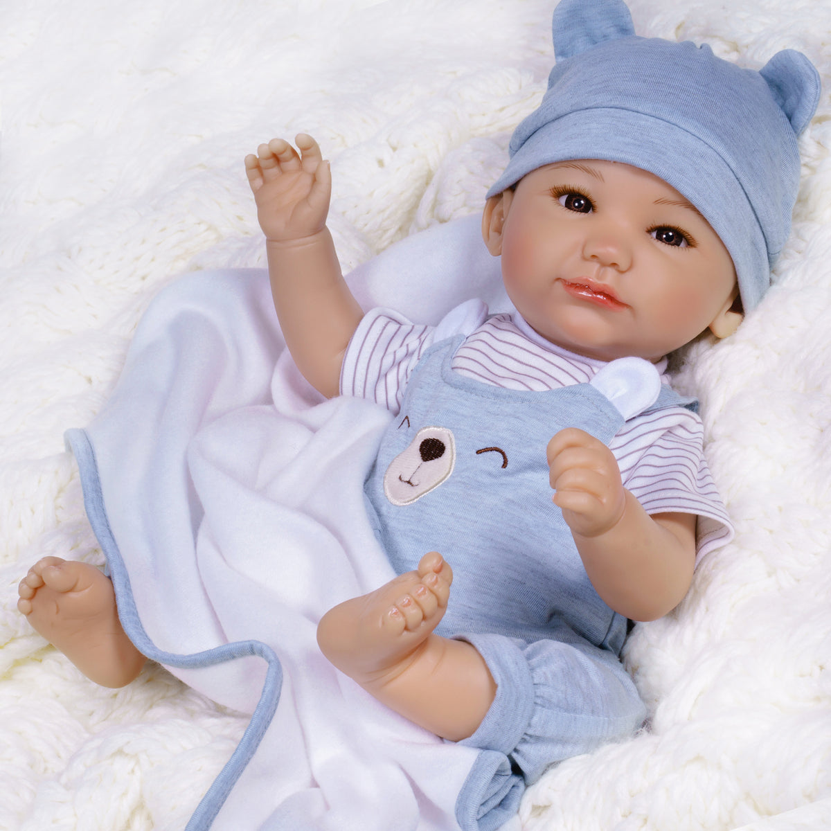 17" Realistic gender neutral newborn doll in Paradise Galleries exclusive GentleTouch Vinyl. Sculpted by award-winning artist, Ping Lau. 