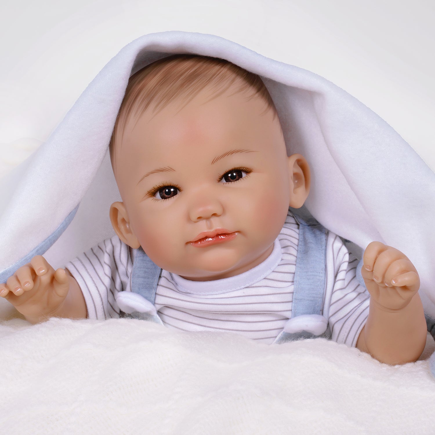 17" Realistic gender neutral newborn doll in Paradise Galleries exclusive GentleTouch Vinyl. Sculpted by award-winning artist, Ping Lau. 