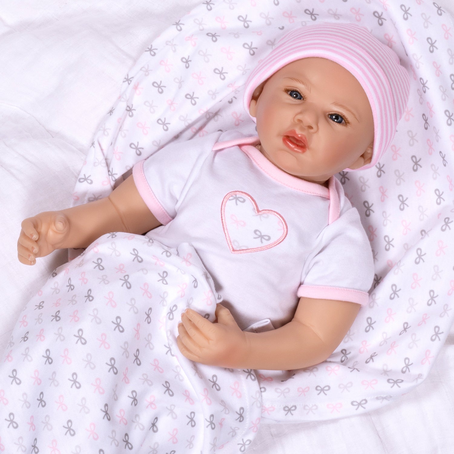 Swaddler Baby Bow Cute - 18" Realistic Doll by Reborn Artist, Michelle Fagan. Made in our exclusive SoftTouch Vinyl for an ultra-realistic feel!